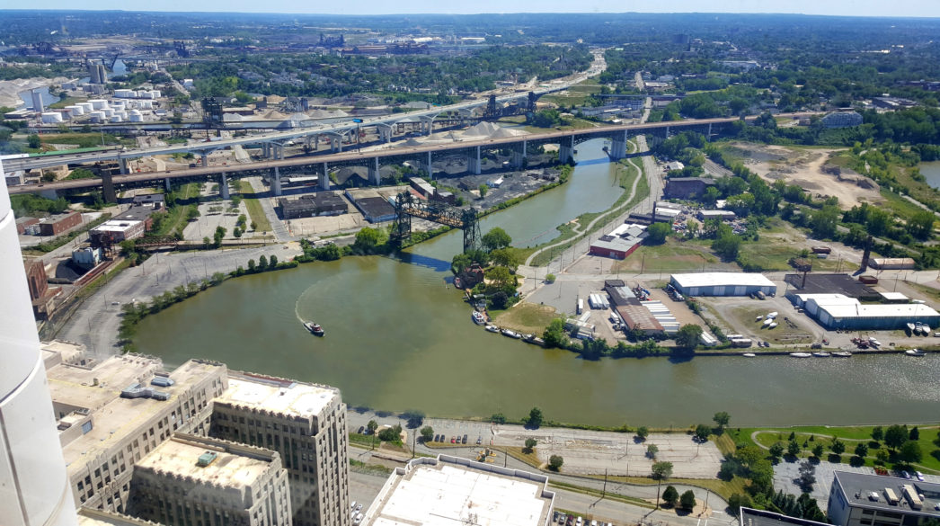 Aerial view of the Cuyahoga River in downtown Cleveland, Ohio, a river surrounded by urban infrastructure.
