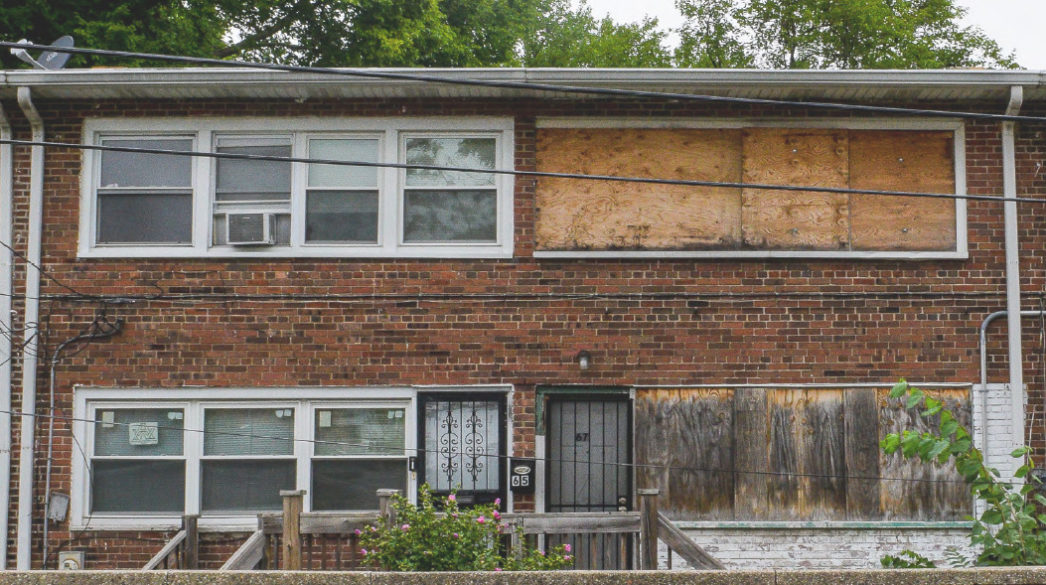 A vacant property with boarded up windows.