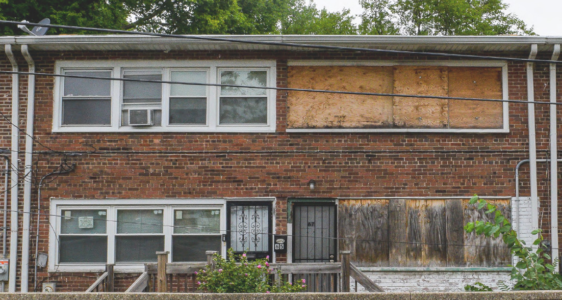A vacant property with boarded up windows.