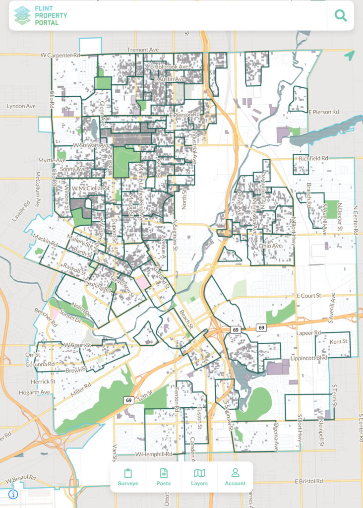 A screenshot of the Flint Property Portal as viewed in the app. It displays a map of the city with vacant parcels/lots colored in grey