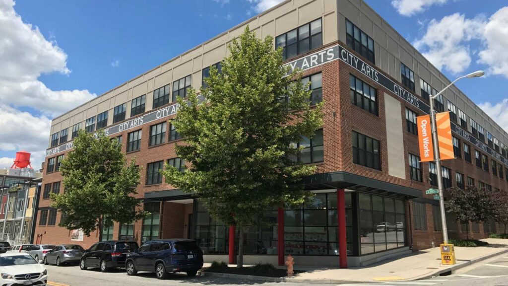 Exterior of the City Arts live-work space, a four-story building made of brick and glass.