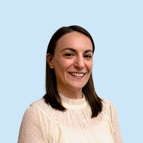 Headshot of Liz Kozub on a blue background